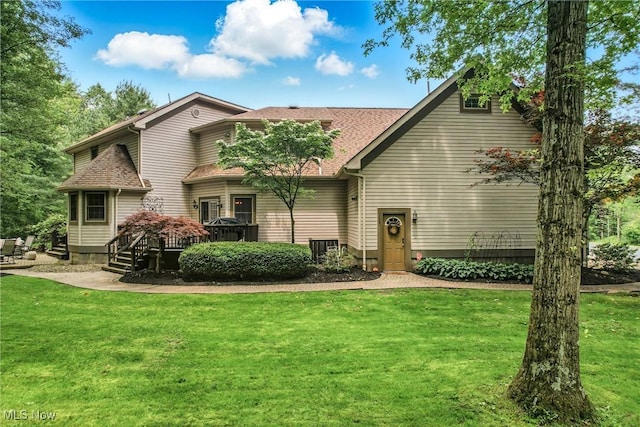 1681 State Rd, Warren, OH 44481 - back of property featuring a lawn, a shingled roof, and a wooden deck