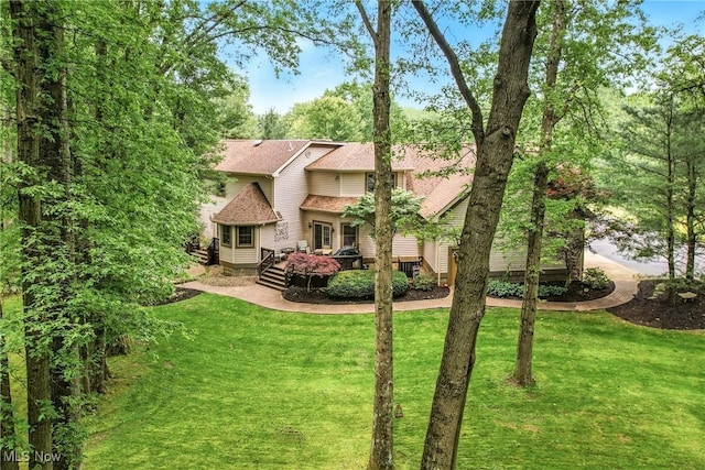 1681 State Rd, Warren, OH 44481 - back of property featuring a wooden deck, a lawn, and a shingled roof
