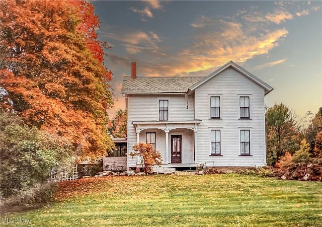 1681 State Rd, Warren, OH 44481 - view of front facade with a chimney, a yard, and covered porch