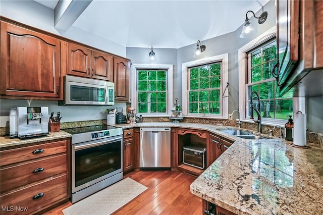 1681 State Rd, Warren, OH 44481 - kitchen with appliances with stainless steel finishes, light stone countertops, and wood-type flooring