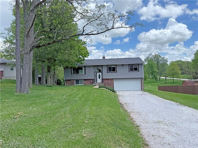 7247 Kiltie Ln, Northfield, OH 44067 - split foyer home featuring driveway, an attached garage, a front yard, a chimney, and brick siding