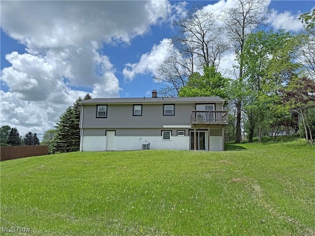 7247 Kiltie Ln, Northfield, OH 44067 - rear view of property featuring a yard, a wooden deck, a chimney, and a garage