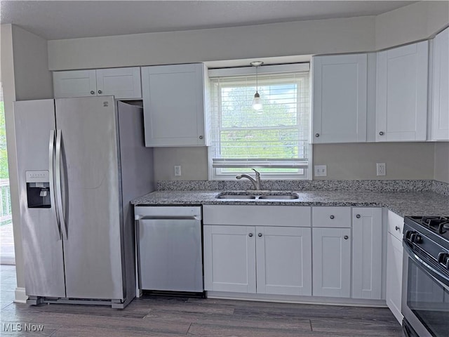 7247 Kiltie Ln, Northfield, OH 44067 - kitchen with stainless steel appliances, white cabinetry, dark wood finished floors, and light stone countertops