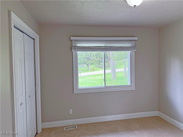 7247 Kiltie Ln, Northfield, OH 44067 - unfurnished bedroom featuring carpet floors, a closet, and a textured ceiling