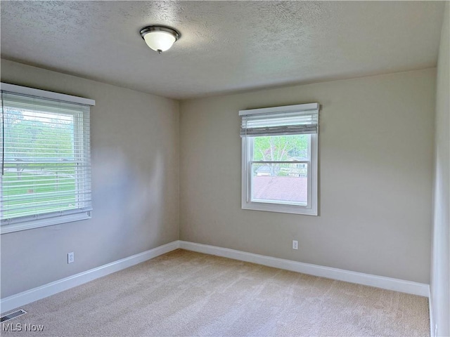 7247 Kiltie Ln, Northfield, OH 44067 - empty room with light colored carpet and a textured ceiling