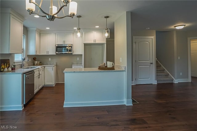 583 Creedmore Ave, Barberton, OH 44203 - kitchen featuring appliances with stainless steel finishes, a chandelier, white cabinetry, dark wood finished floors, and recessed lighting