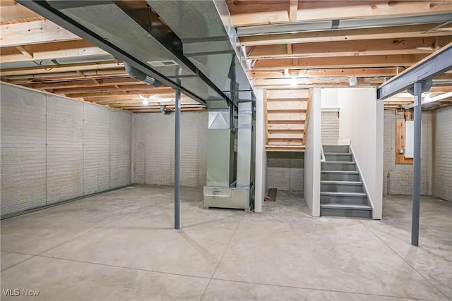 583 Creedmore Ave, Barberton, OH 44203 - unfinished basement with stairway, heating unit, and brick wall