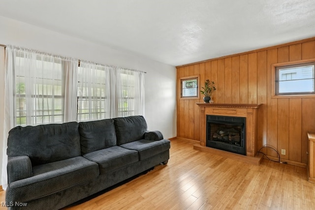 447 Allenford St, Akron, OH 44314 - living area with plenty of natural light, hardwood / wood-style flooring, a fireplace with raised hearth, and wood walls