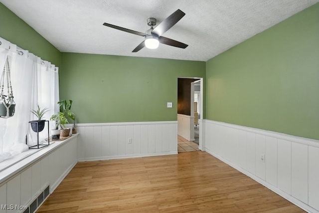 447 Allenford St, Akron, OH 44314 - unfurnished room with wood finished floors, ceiling fan, and wainscoting