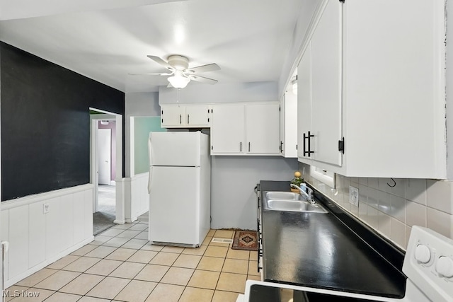 447 Allenford St, Akron, OH 44314 - kitchen with freestanding refrigerator, a ceiling fan, white cabinetry, decorative backsplash, and light tile patterned flooring