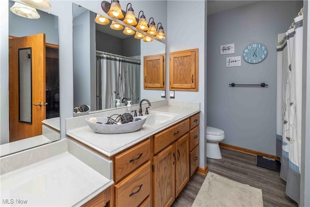 937 Amundsen Dr, Canal Fulton, OH 44614 - bathroom featuring wood finished floors, vanity, and a shower with shower curtain