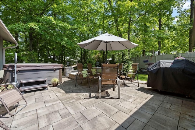 12145 The Blfs, Strongsville, OH 44136 - view of patio / terrace with a hot tub, area for grilling, outdoor dining area, and view of scattered trees