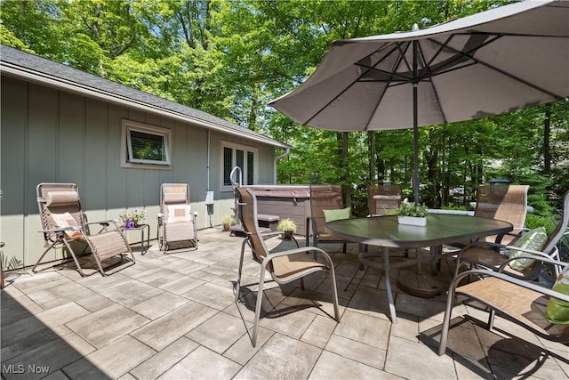 12145 The Blfs, Strongsville, OH 44136 - view of patio / terrace featuring a hot tub, outdoor dining space, and view of scattered trees