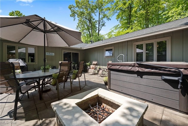 12145 The Blfs, Strongsville, OH 44136 - deck with a hot tub, a fire pit, a patio area, outdoor dining space, and a grill