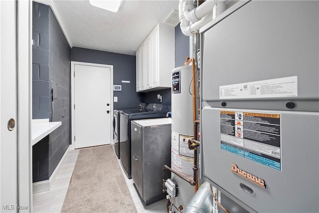 12145 The Blfs, Strongsville, OH 44136 - laundry room with heating unit, washer and clothes dryer, cabinet space, a textured ceiling, and concrete block wall