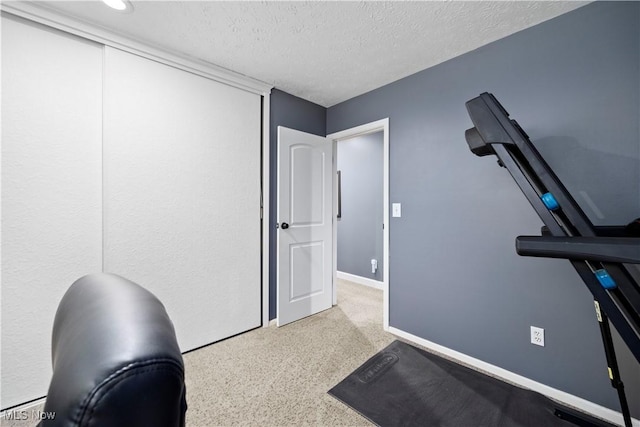 12145 The Blfs, Strongsville, OH 44136 - workout room featuring a textured ceiling and baseboards