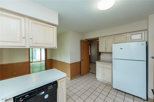 2375 Glendon Rd, University Heights, OH 44118 - kitchen with freestanding refrigerator, black dishwasher, a wainscoted wall, wooden walls, and light countertops
