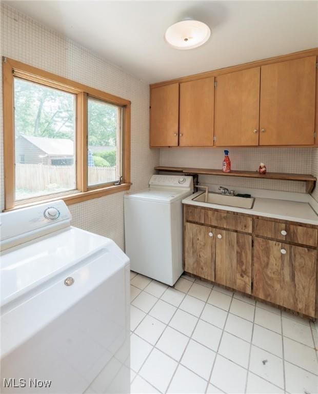2375 Glendon Rd, University Heights, OH 44118 - laundry room with washer and clothes dryer, wallpapered walls, cabinet space, and light tile patterned floors