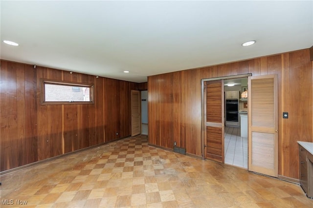 2375 Glendon Rd, University Heights, OH 44118 - spare room with wood walls, light flooring, and recessed lighting