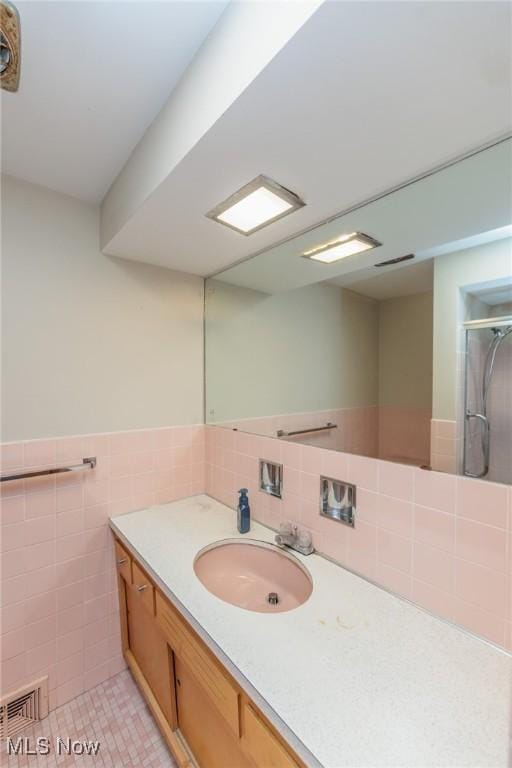 2375 Glendon Rd, University Heights, OH 44118 - full bath with vanity, an enclosed shower, tile walls, a wainscoted wall, and tile patterned flooring