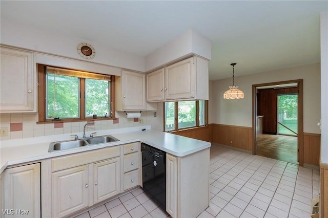 2375 Glendon Rd, University Heights, OH 44118 - kitchen with dishwasher, a wainscoted wall, a peninsula, light countertops, and pendant lighting