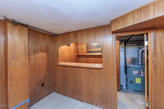 2375 Glendon Rd, University Heights, OH 44118 - bar featuring wooden walls, heating unit, and concrete floors