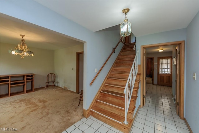2375 Glendon Rd, University Heights, OH 44118 - stairway with tile patterned floors and a chandelier