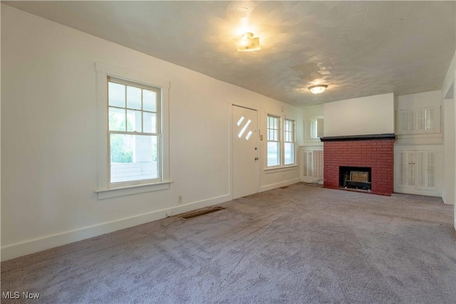996 Peerless Ave, Akron, OH 44320 - unfurnished living room with a fireplace and carpet flooring