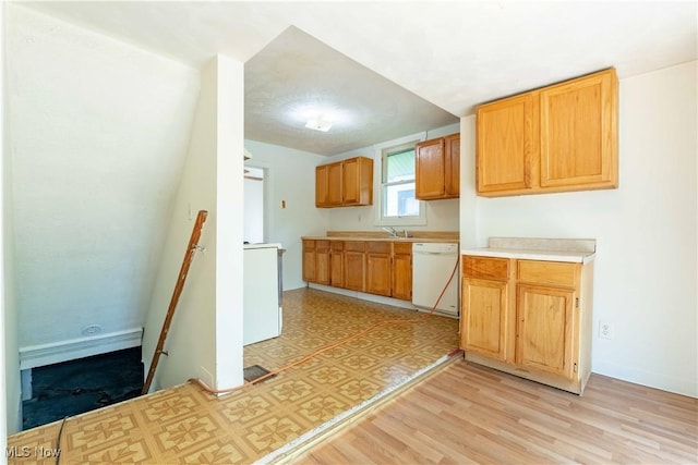 996 Peerless Ave, Akron, OH 44320 - kitchen with dishwasher, light countertops, light wood-style flooring, and washer / clothes dryer