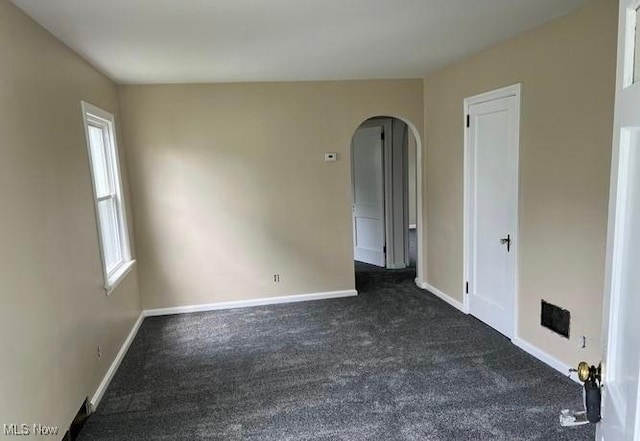 920 Washington Ave, Girard, OH 44420 - unfurnished room with dark carpet and arched walkways