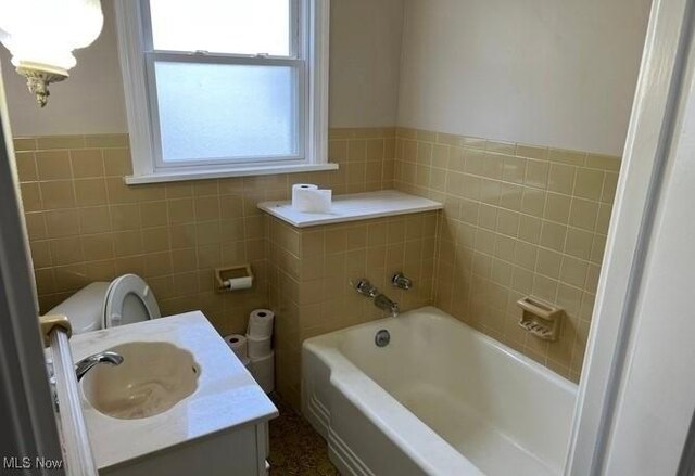 920 Washington Ave, Girard, OH 44420 - bathroom with tile walls, a bath, and vanity
