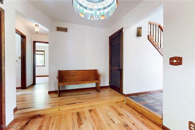 5864 State Route 213, Toronto, OH 43964 - hall with wood finished floors, stairs, and a chandelier