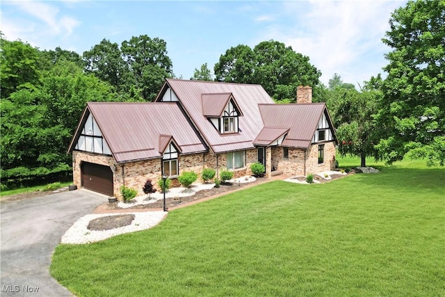 5864 State Route 213, Toronto, OH 43964 - english style home featuring a garage, a front yard, asphalt driveway, a chimney, and a metal roof