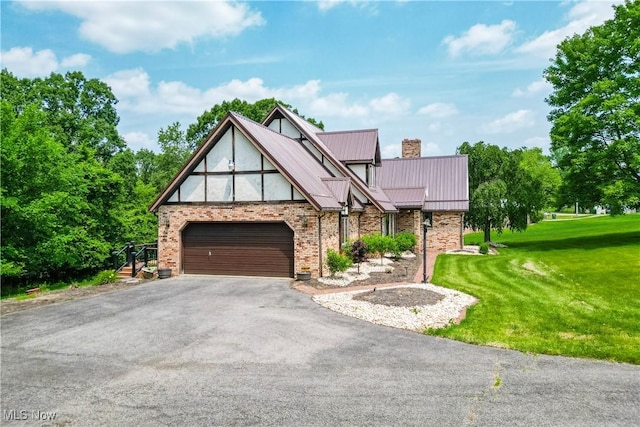5864 State Route 213, Toronto, OH 43964 - tudor-style house with driveway, a front lawn, an attached garage, a chimney, and a metal roof