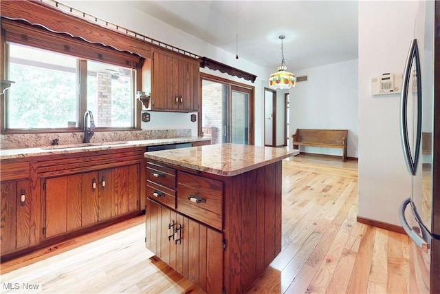 5864 State Route 213, Toronto, OH 43964 - kitchen featuring freestanding refrigerator, light wood-style floors, healthy amount of natural light, and brown cabinetry