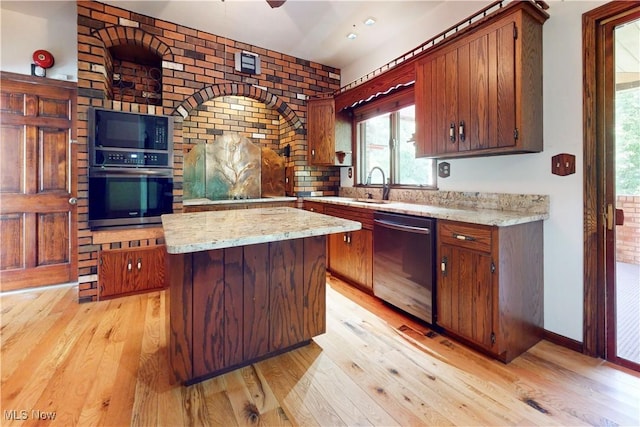 5864 State Route 213, Toronto, OH 43964 - kitchen with appliances with stainless steel finishes, light wood finished floors, a center island, and light stone counters