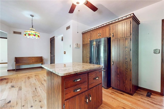 5864 State Route 213, Toronto, OH 43964 - kitchen with freestanding refrigerator, light wood-style flooring, ceiling fan, decorative light fixtures, and a center island