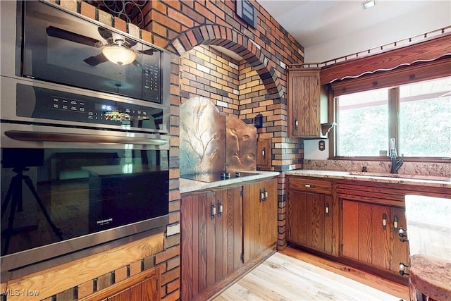 5864 State Route 213, Toronto, OH 43964 - kitchen with oven, light wood-style floors, brown cabinets, and ceiling fan