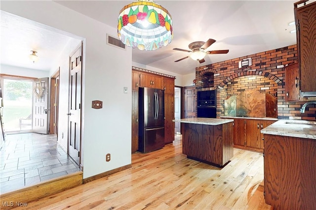 5864 State Route 213, Toronto, OH 43964 - kitchen with freestanding refrigerator, a ceiling fan, oven, brown cabinetry, and a kitchen island