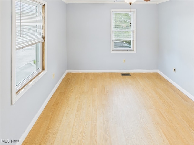 1317 Crescent St, Parkersburg, WV 26101 - empty room featuring light wood-style floors, crown molding, and ceiling fan