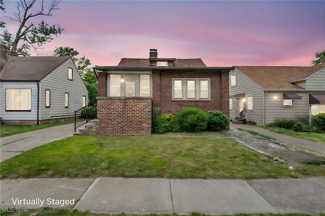 4532 W 172nd St, Cleveland, OH 44135 - bungalow-style home with a chimney, a yard, and brick siding