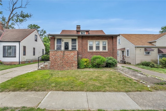 4532 W 172nd St, Cleveland, OH 44135 - bungalow featuring brick siding, a front yard, and a chimney