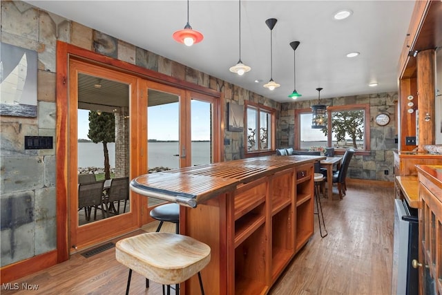 731 Cedar Point Rd, Sandusky, OH 44870 - kitchen with french doors, light wood-style floors, butcher block counters, open shelves, and pendant lighting