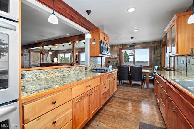 731 Cedar Point Rd, Sandusky, OH 44870 - kitchen with appliances with stainless steel finishes, tile counters, dark wood finished floors, decorative light fixtures, and recessed lighting