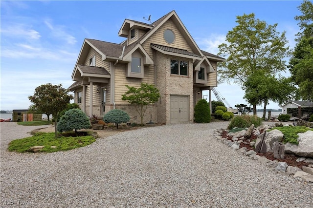 731 Cedar Point Rd, Sandusky, OH 44870 - view of home's exterior featuring gravel driveway, brick siding, and a garage