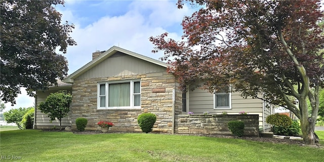 36277 Butcher Rd, Salem, OH 44460 - view of front of house with stone siding, a chimney, and a front yard