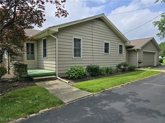 36277 Butcher Rd, Salem, OH 44460 - view of side of property with driveway, an attached garage, and roof with shingles