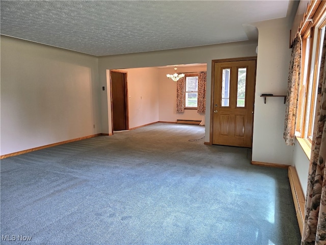 36277 Butcher Rd, Salem, OH 44460 - empty room featuring a chandelier, a baseboard heating unit, carpet floors, and a textured ceiling