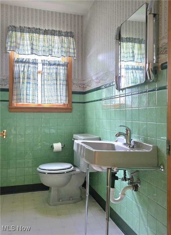 36277 Butcher Rd, Salem, OH 44460 - half bathroom with wallpapered walls, tile walls, plenty of natural light, tile patterned floors, and wainscoting