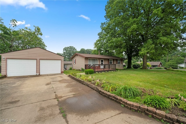 2100 Priscilla Ave NW, Massillon, OH 44647 - view of front of property with a detached garage, an outdoor structure, a front yard, and a wooden deck